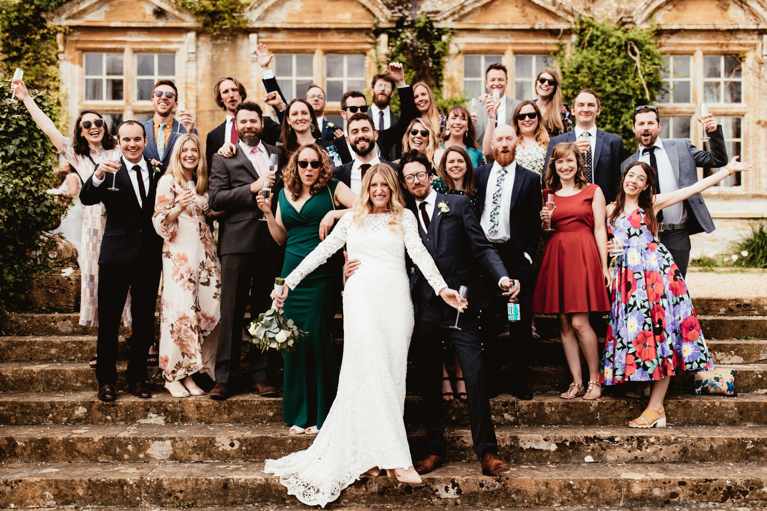Couple and guests standing outside of their wedding venue in the south west called Brympton House