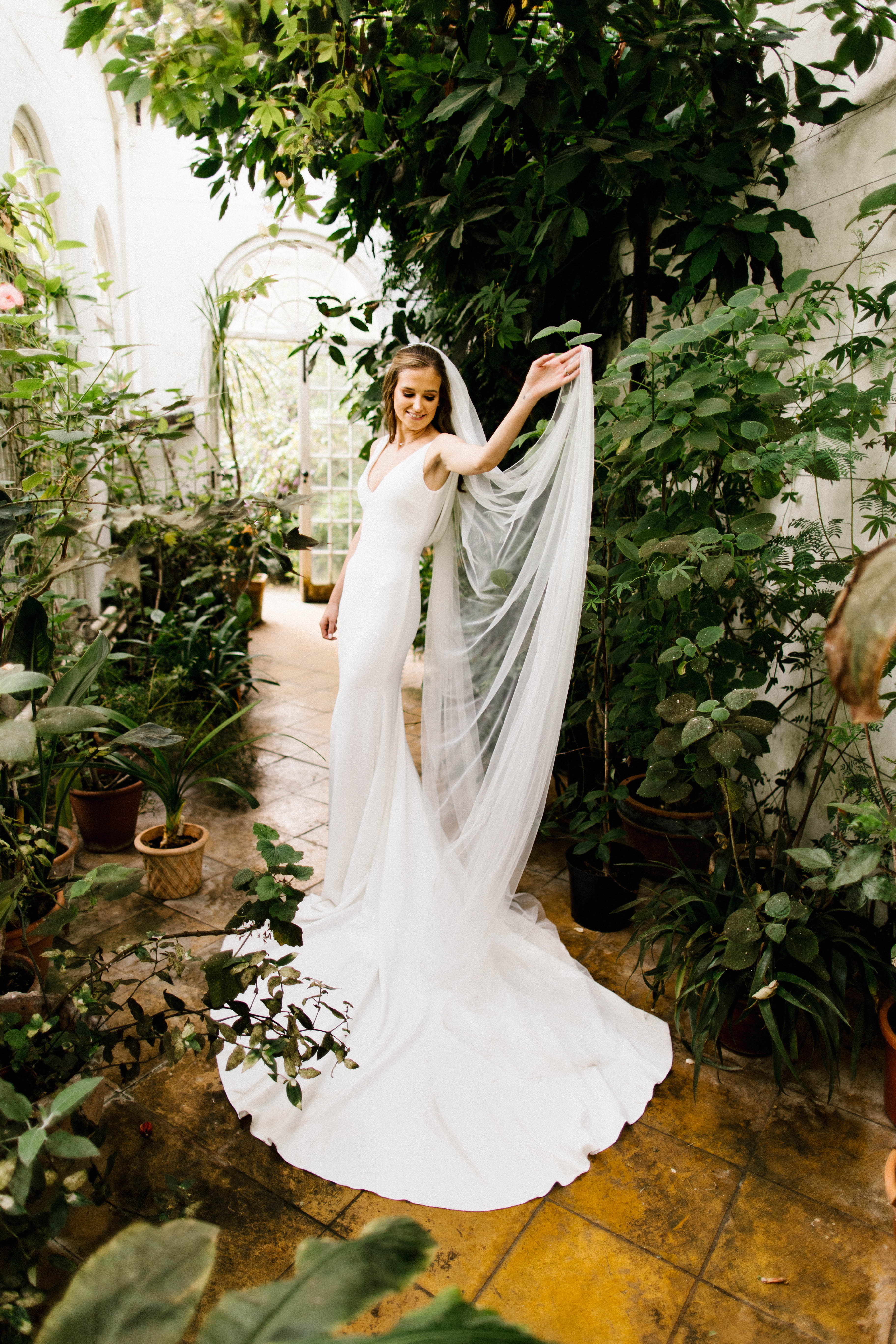 Bride portrait surrounded by greenery indoors at a south west wedding venue called Mapperton House