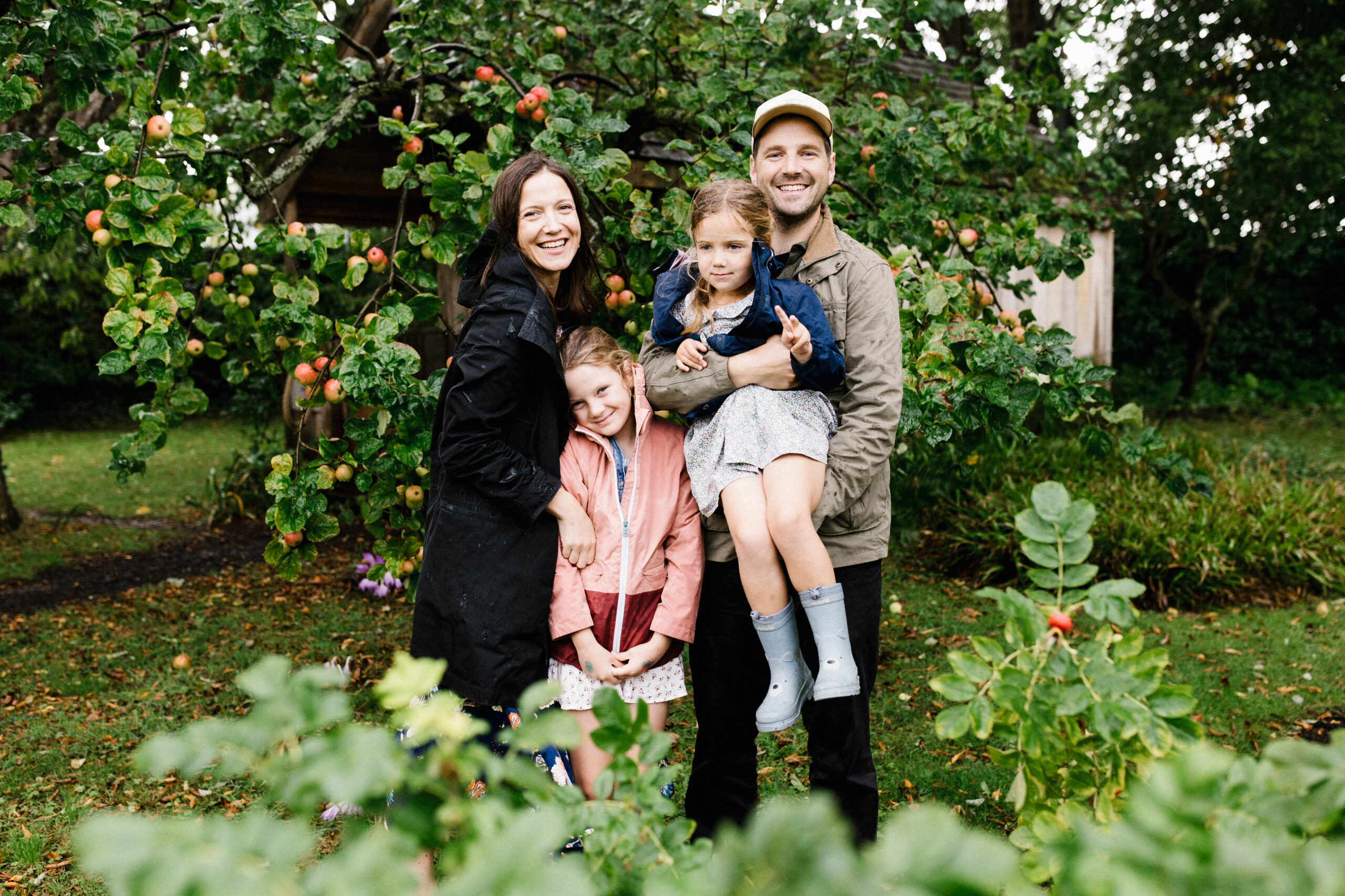 Outdoor family photo in Bristol surrounded by greenery of the trees