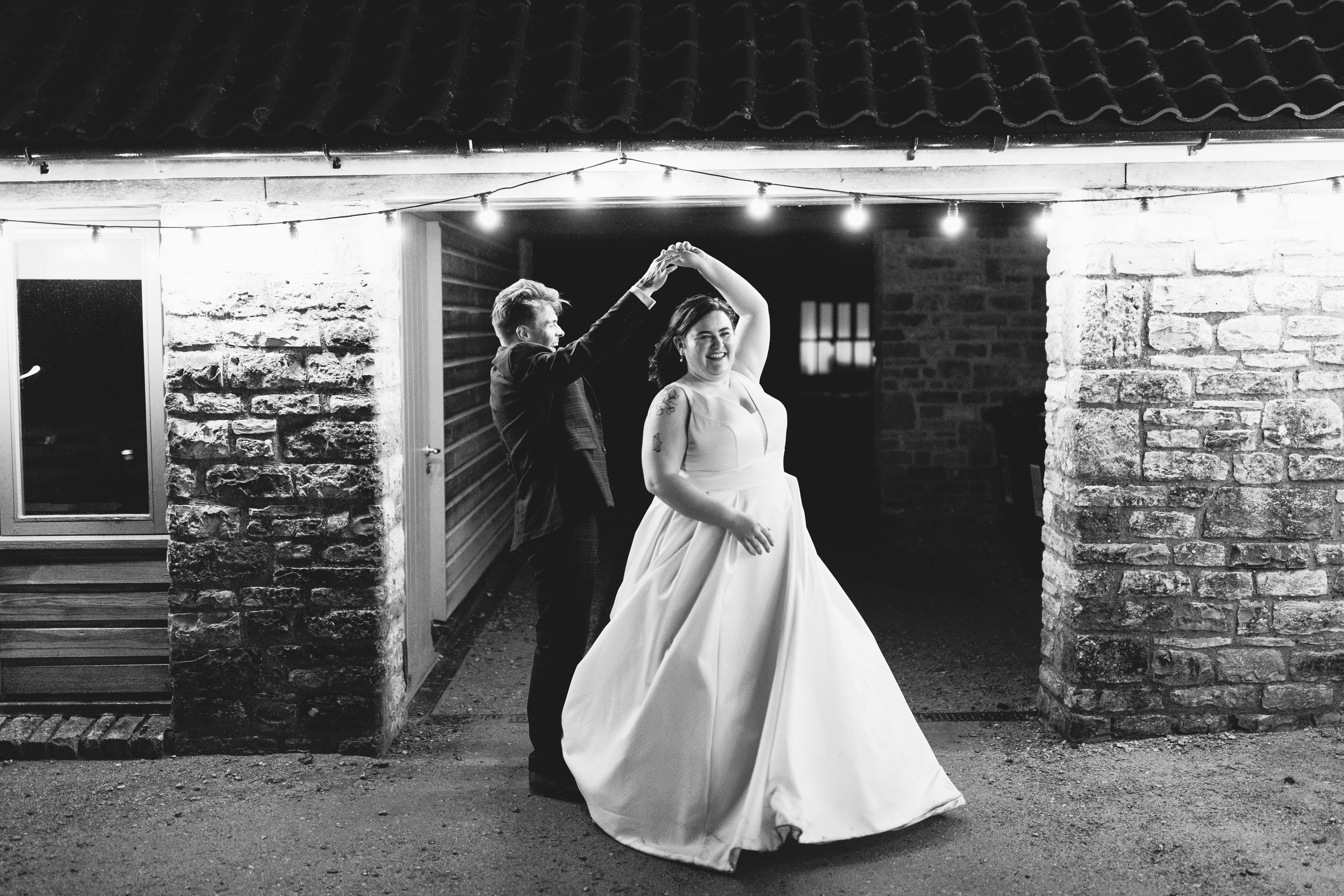 Black and white outdoor couple shot at Barn wedding venue called Folly Farm