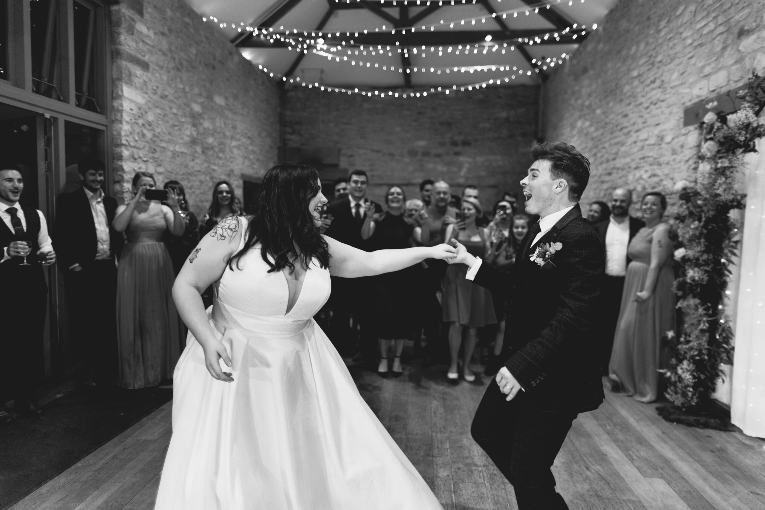 Black and white shot of the couple dancing at Barn wedding venue called Folly Farm