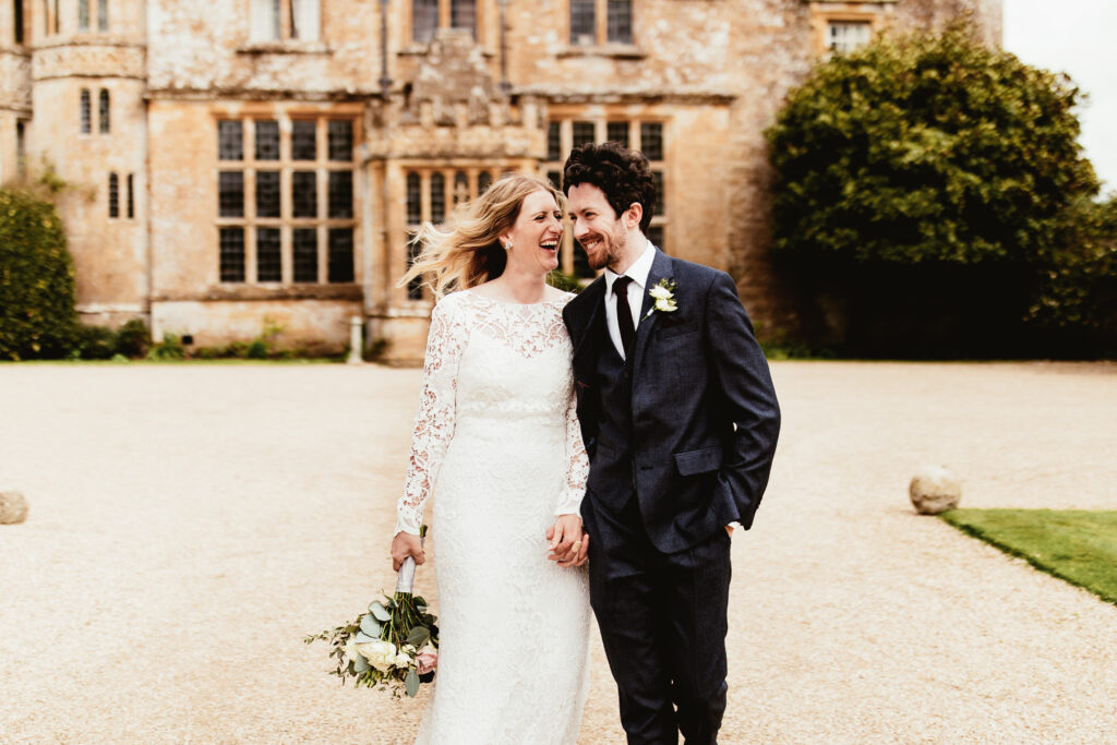 Couple standing outside of their wedding venue in the south west called Brympton House