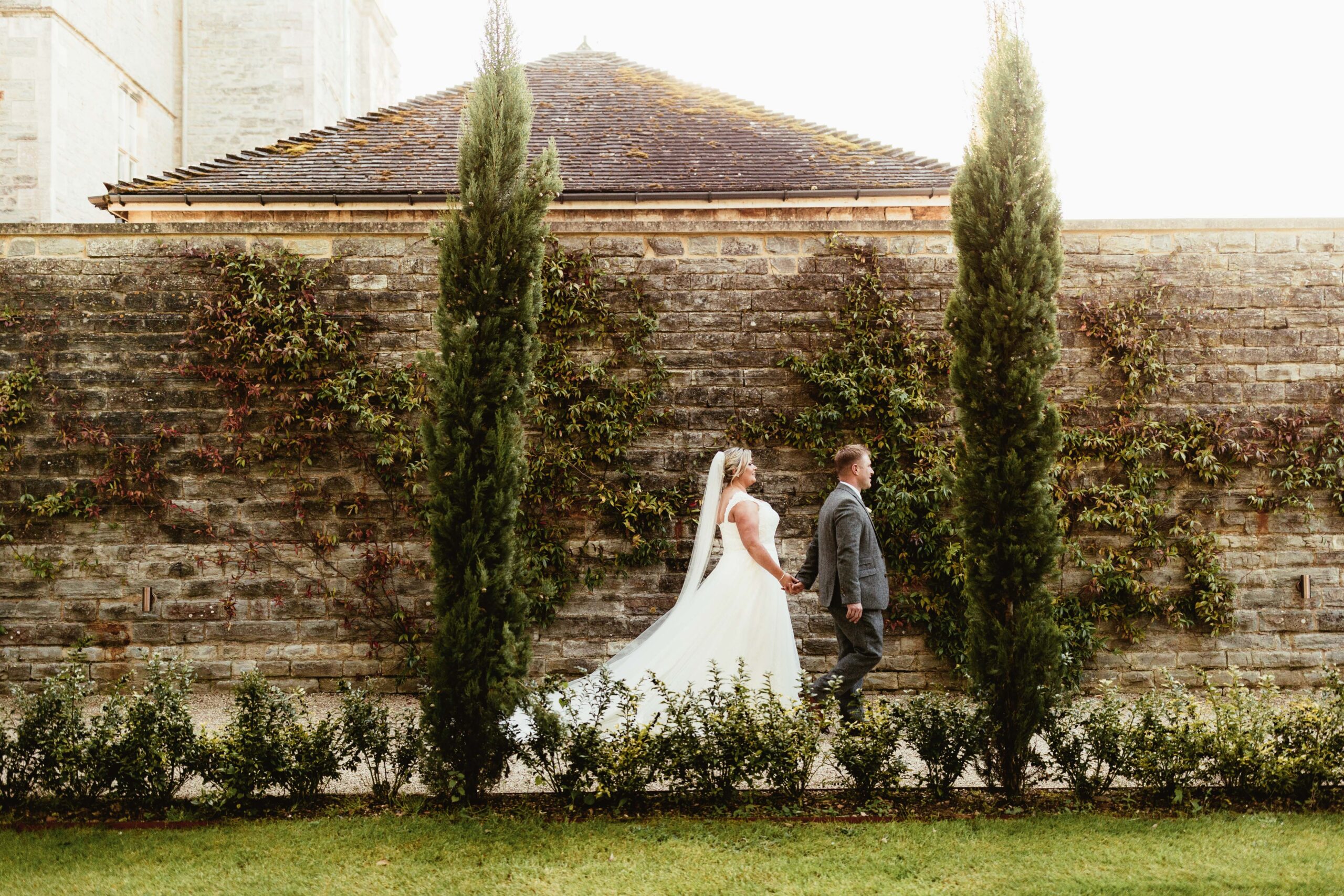 Bride groom walking outdoors at a wedding venue in the south west called Elmore Court 