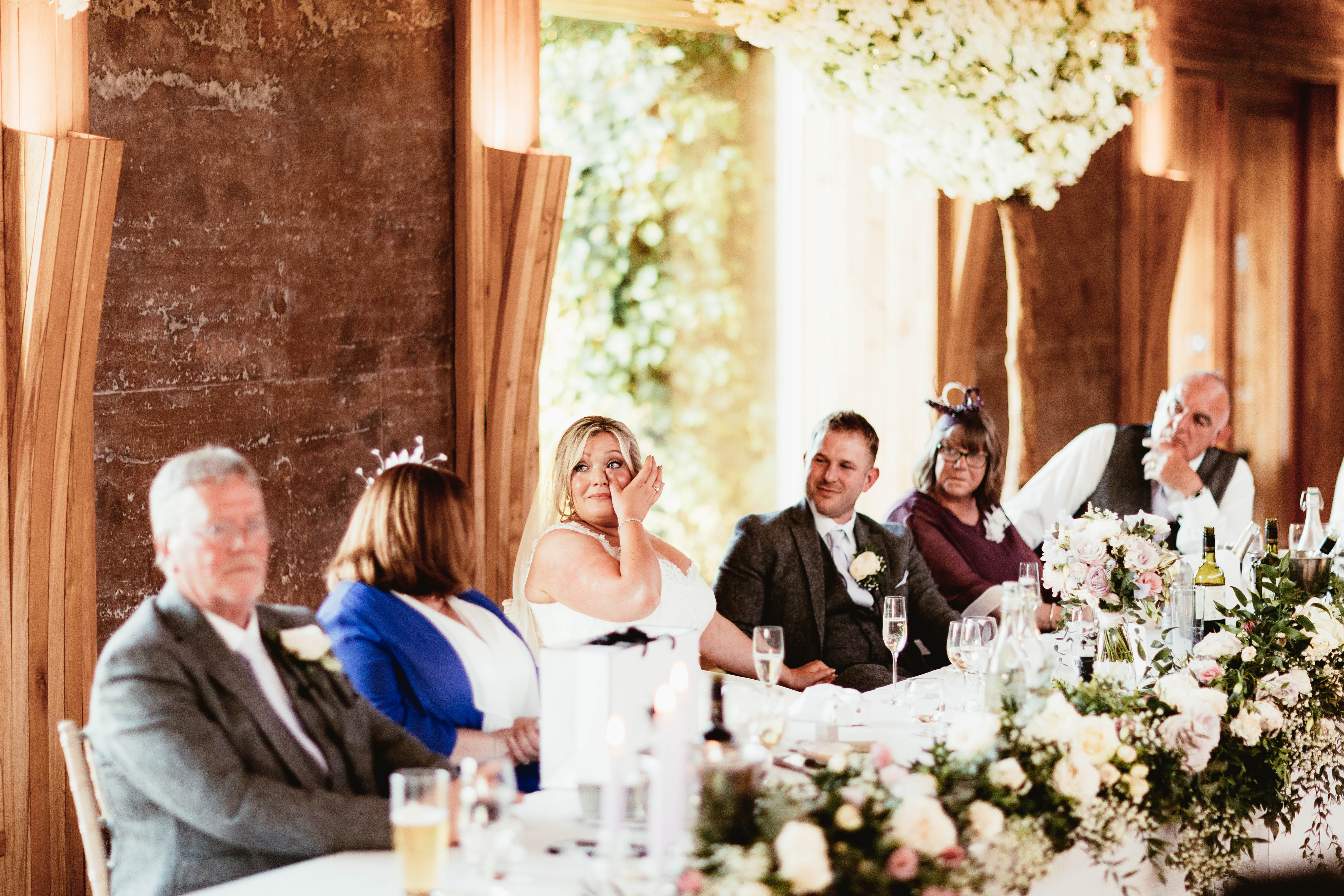 Bride and groom during speeches at a wedding venue in the south west called Elmore Court 