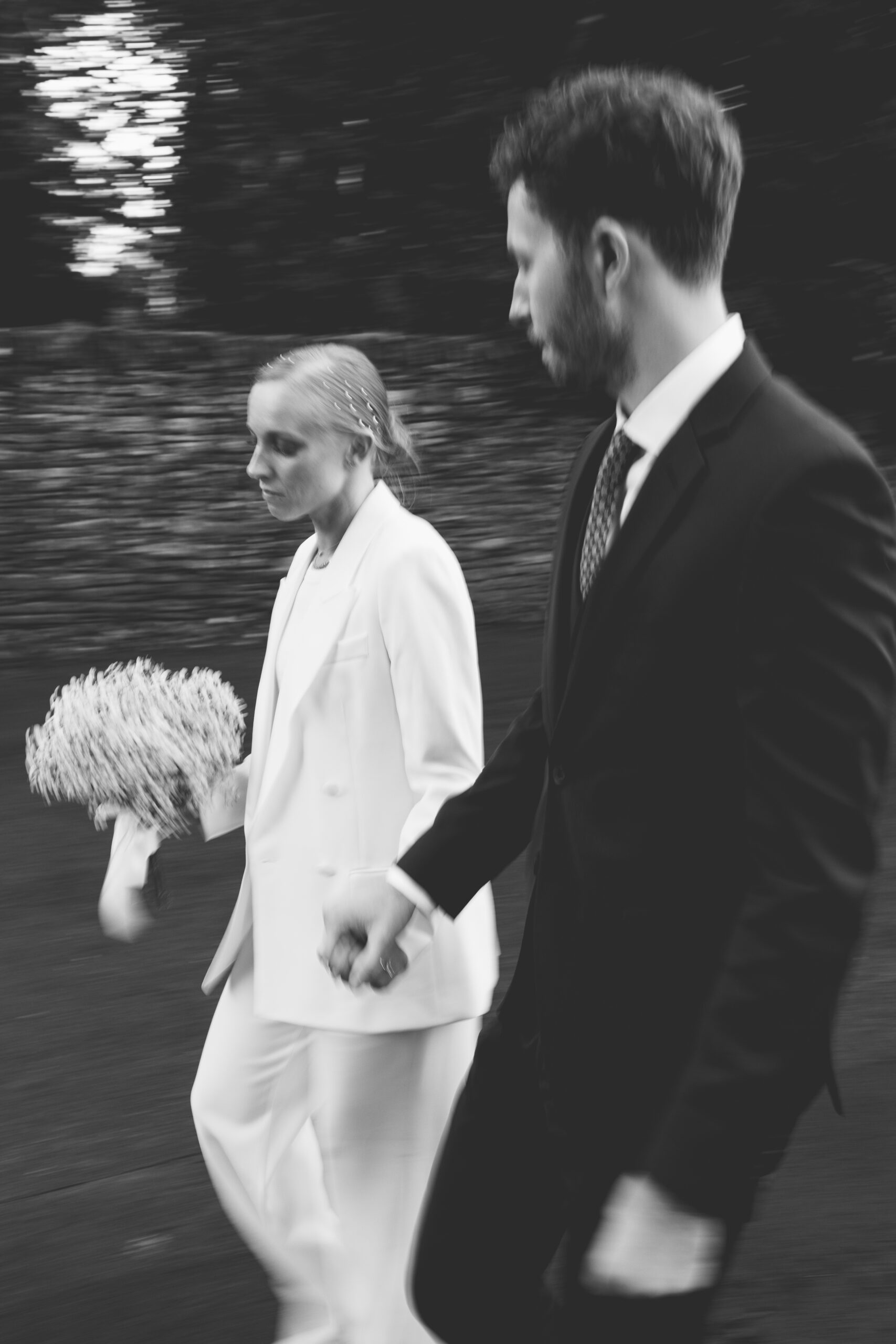 Black and white couple portrait walking outdoors at their barn wedding venue called Wild Thyme and Honey