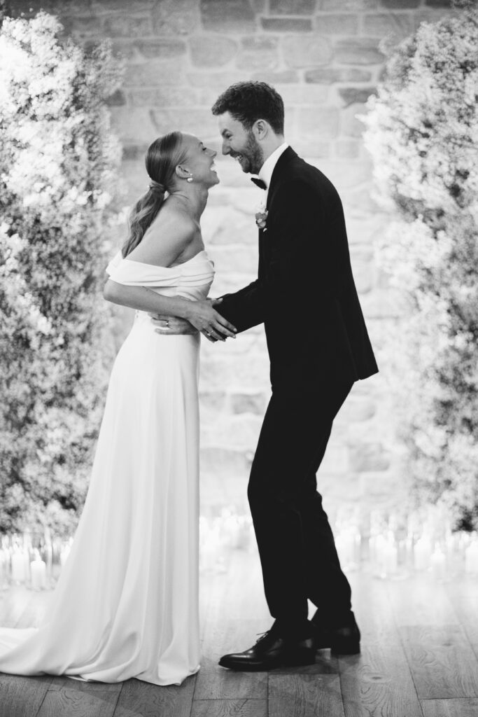 Couple portrait during their ceremony at their barn wedding venue called Wild Thyme and Honey
