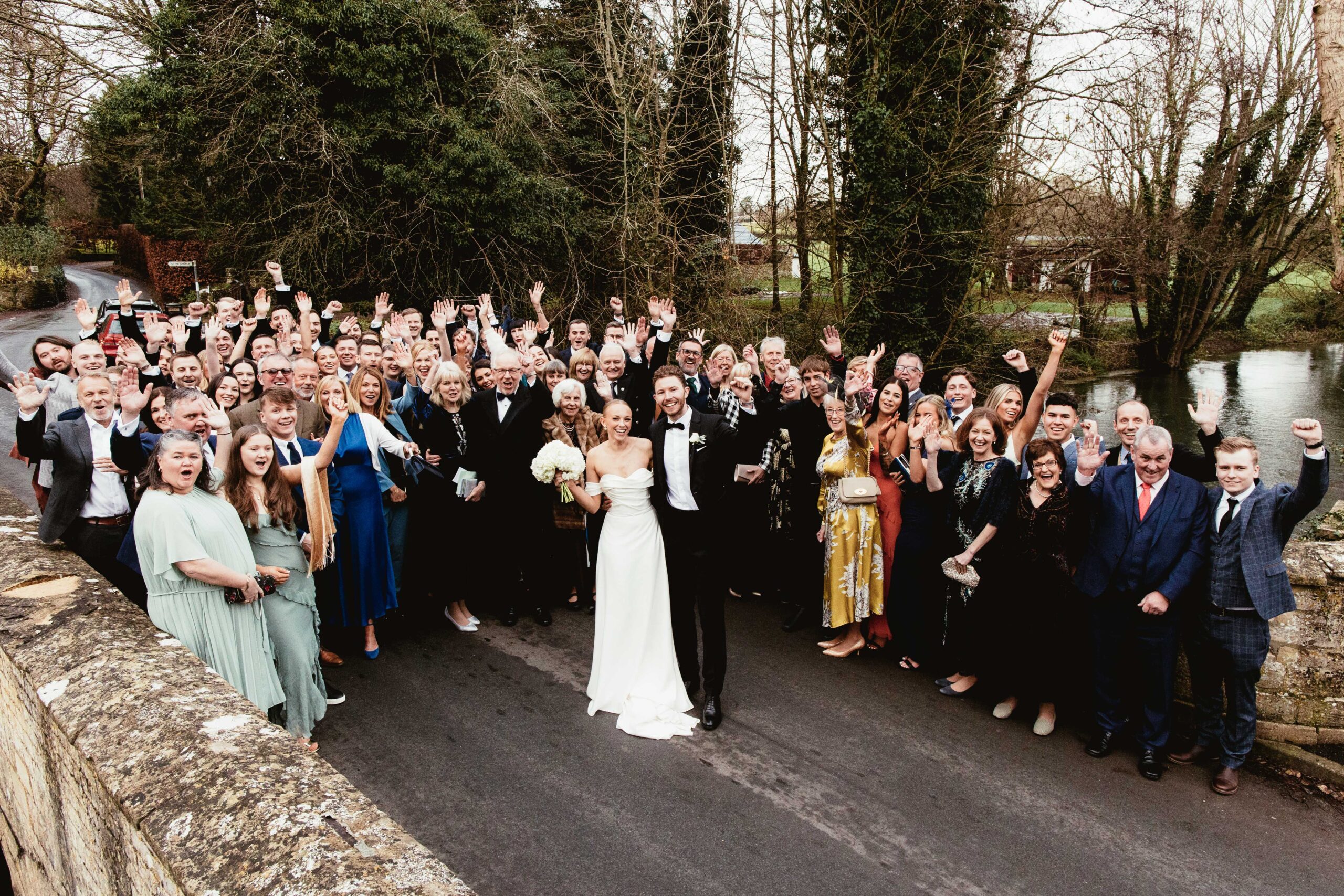 Couple and their guests group photo at their barn wedding venue called Wild Thyme and Honey