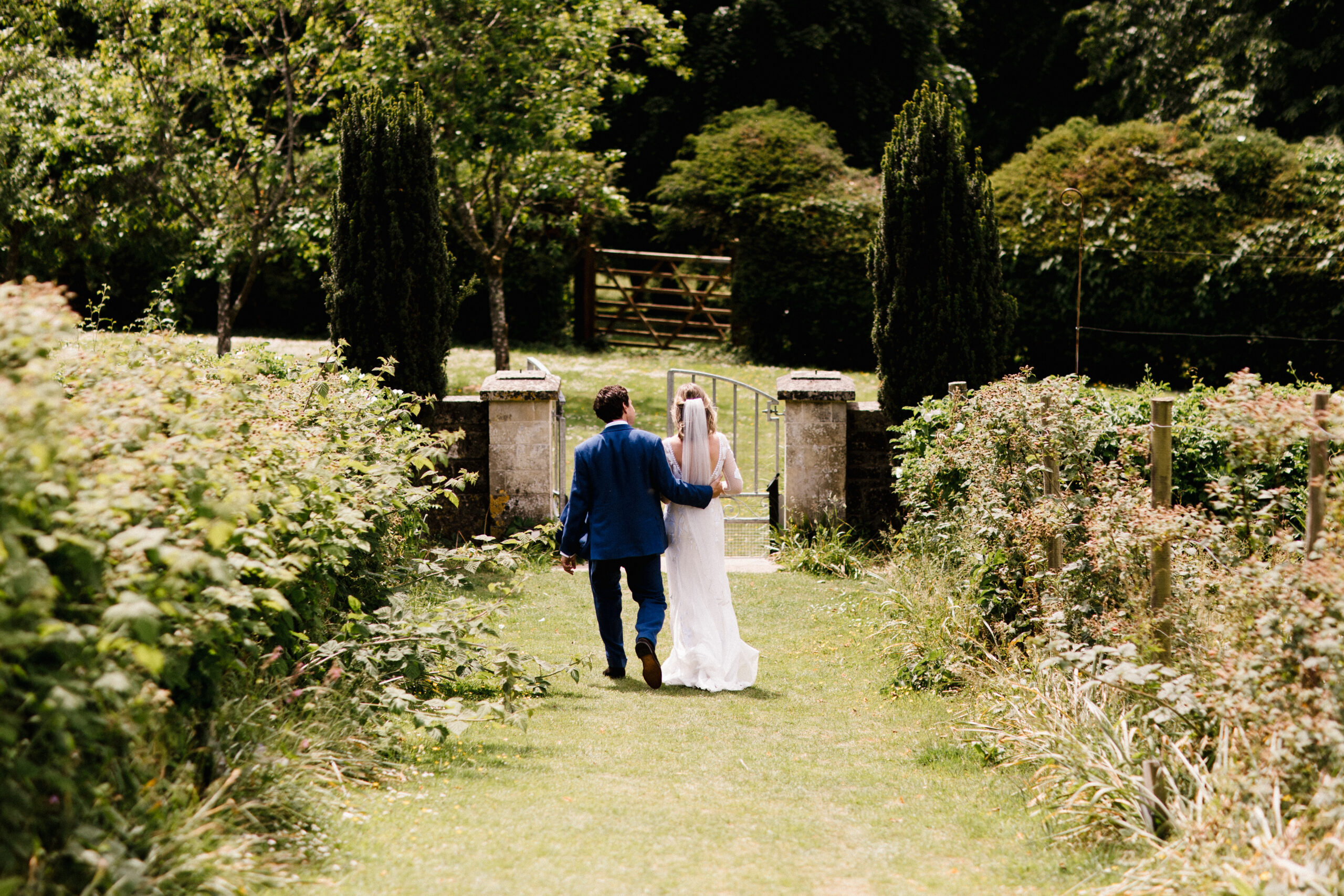 Couple walking outdoors at their South west wedding venue at Pythouse Kitchen Garden