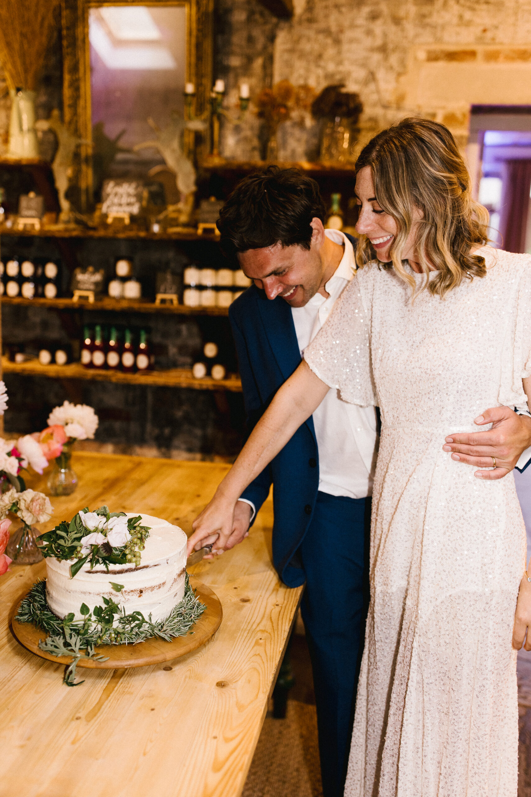 Bride and groom cutting their wedding cake at their South west wedding venue at Pythouse Kitchen Garden